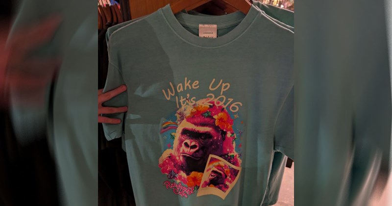 A blue t-shirt with a Gorilla on it saying 'Wake Up, It's 2016,' heavily implying that the gorilla is meant to be Harambe