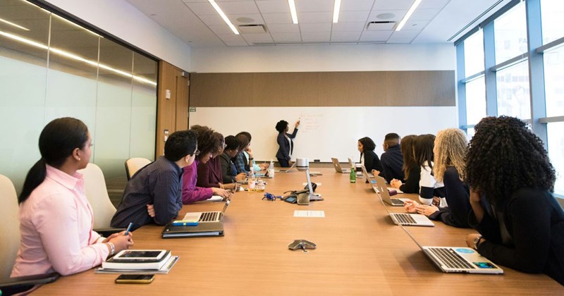 Employee giving presentation in conference room an hour after she was told to start said presentation