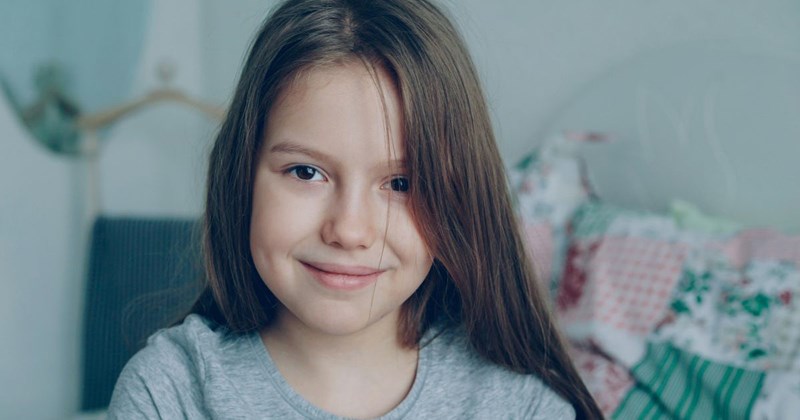10-year-old girl mischievously smiles after destroying her older sisters bedroom