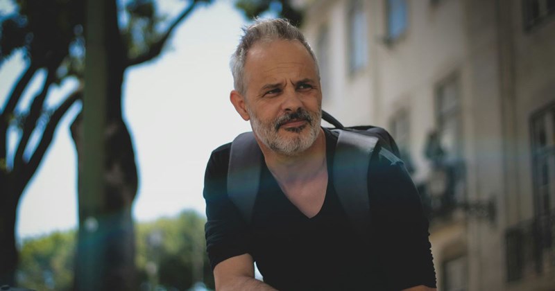 Stepdad with backpack contemplates his relationship with his adult son