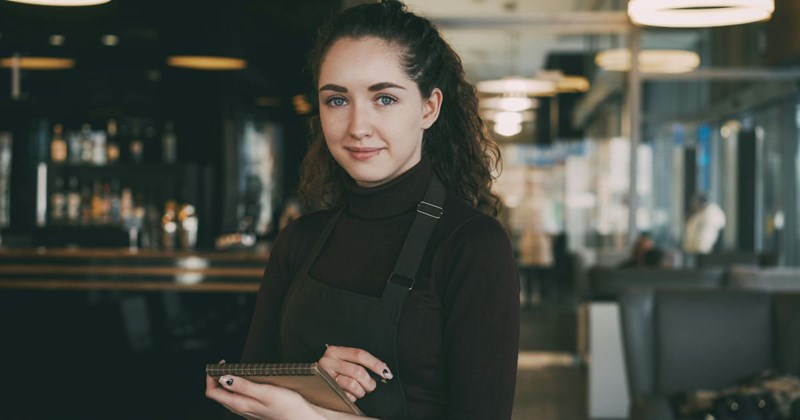 A young college student works as a barista when she's not in class.