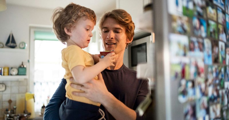 Young dad holds his toddler son, hoping to move in with his girlfriend and her roommate.