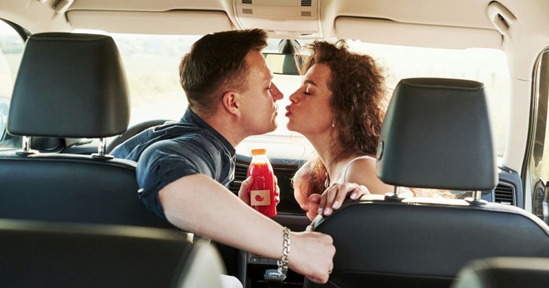 A couple, who have been together for only two months, kiss in the car they bought together.