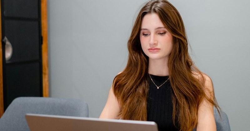 A young mom works at her part-time job while her kids are at school. 