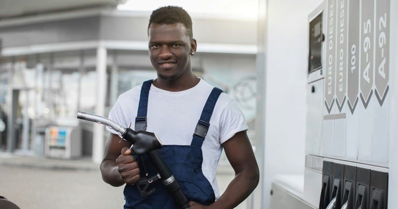 A young man works his first day at his new job at the gas station.