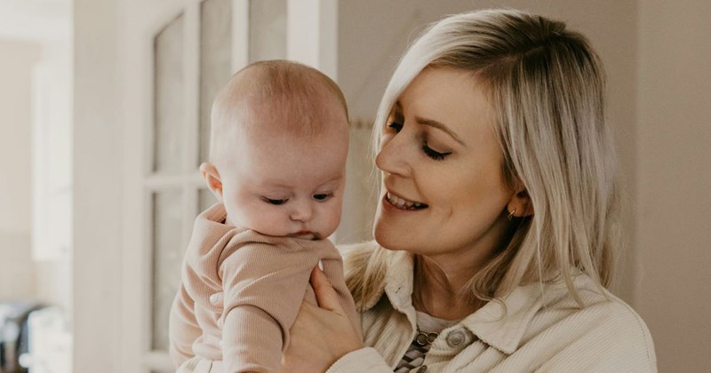 A mom holds her baby, whom she does not trust to be held by her 7-year-old niece. 