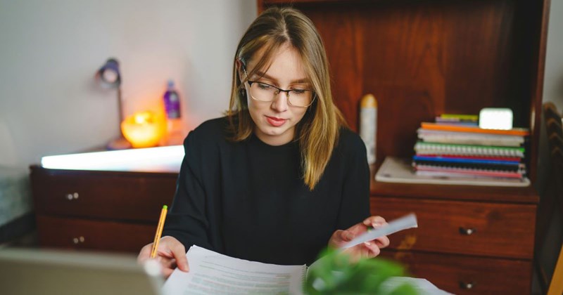 A teacher grades her students essays, wishing that she was doing anything else. 