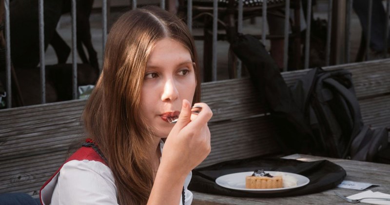 Employee eats cake during her lunch break at work. 