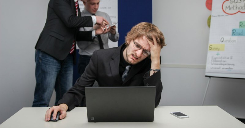 A picture of a model pretending to be a stressed-out employee who just found out his pay is getting cut by $50K.