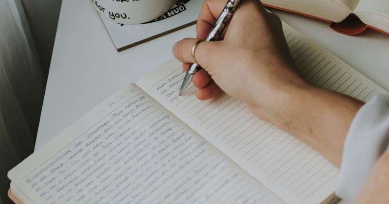 A representation of a young woman writing in her old diary, which she does not want her husband to read. 