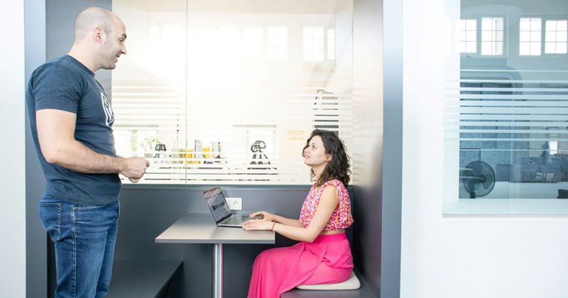 Models representing a male employee flirting with his female manager when she's trying to get work done by herself. 