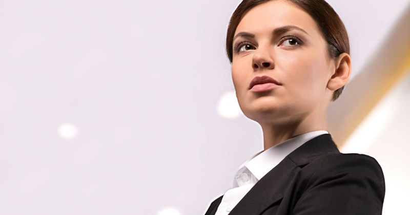 A smartly dressed female employee looks to the side