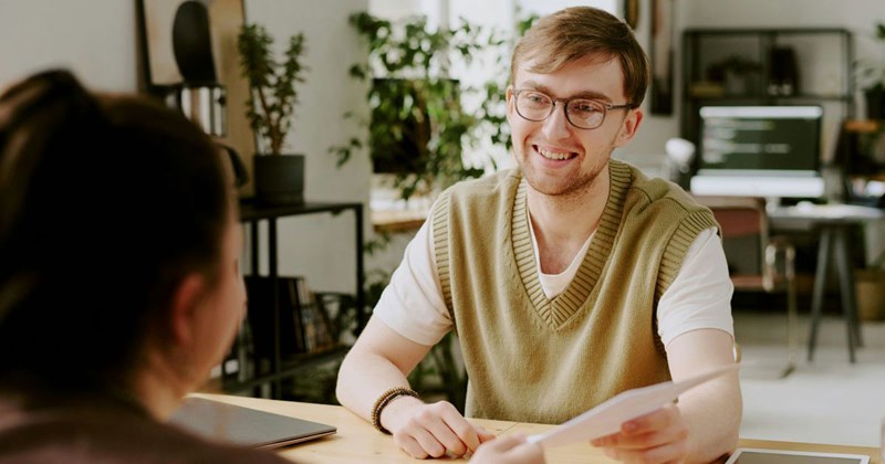 A young professional interviewing at a competitor of his current company, without the knowledge that the higher-ups at both companies are going to ruin any chance he has of getting the job. 