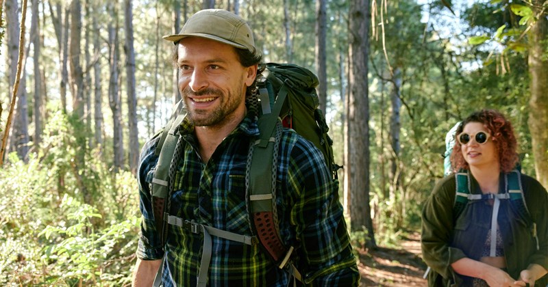A boyfriend goes on a hike with his girlfriend, who was the one who introduced him to outdoor hobbies.