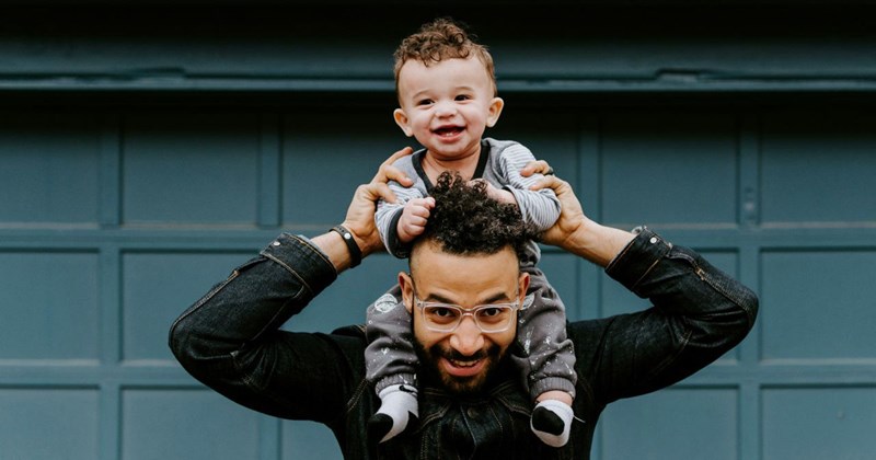 Dad brings his toddler son to his office to drop off his work laptop after he got laid off. 