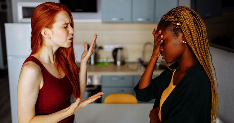 Two women fighting in a kitchen