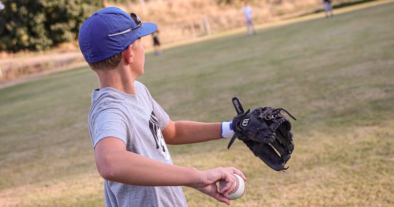Kids playing baseball in the backyard