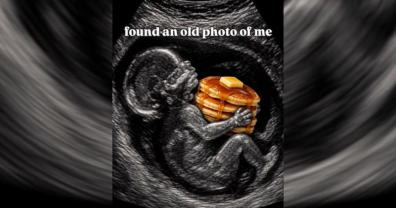 An ultrasound baby holding a stack of pancakes